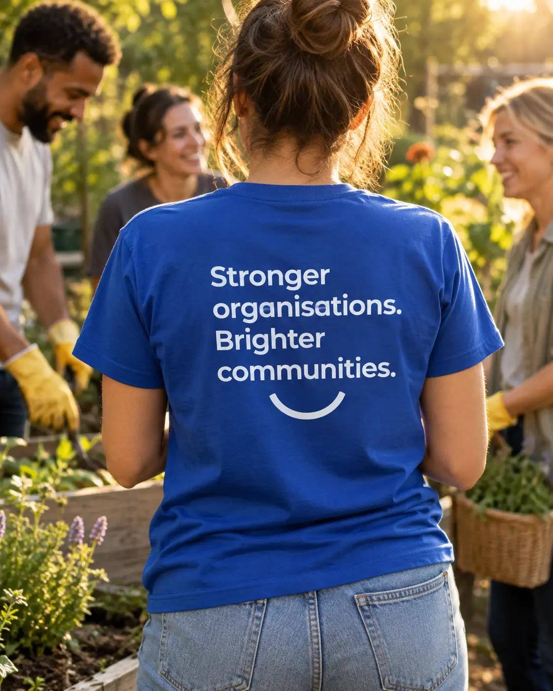 Illustrative volunteer wearing a cobalt shirt reading ‘Stronger organisations. Brighter communities.’